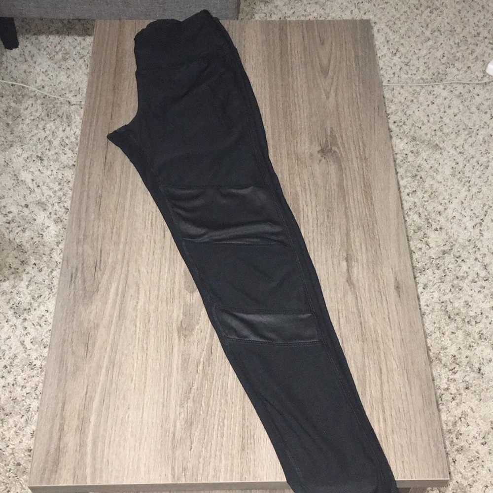Black spandex leggings with leather patches